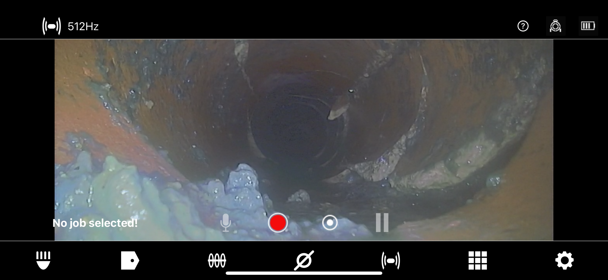 A camera view looking down the inside of a corroded pipe, ideal for sewer inspection, repair, and replacement, with video recording controls and status indicators displayed on screen.